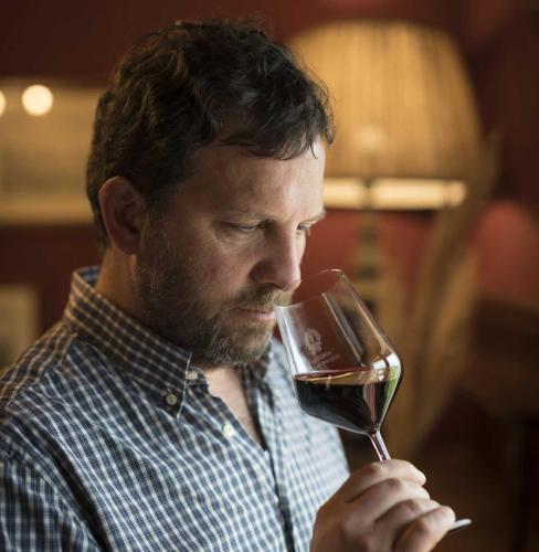 a man drinking a glass of red wine at Fattoria Casagrande in Rignano sullʼArno