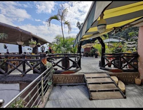 a patio with stairs and a building with a umbrella at HOTEL POLOMAX in Nainital