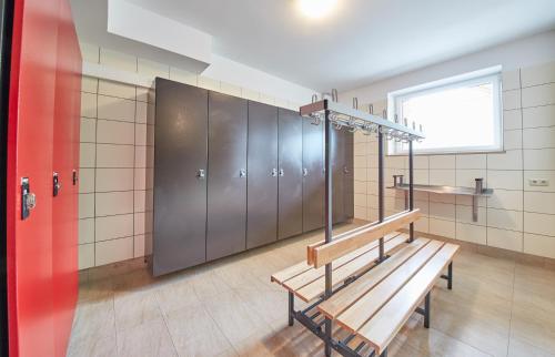 a locker room with a bench and lockers at Am Mitteregghof in Saalbach Hinterglemm