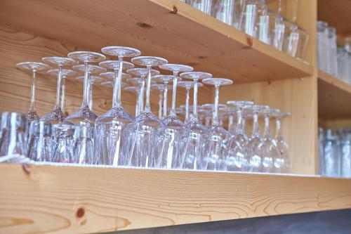 a bunch of glasses sitting on a shelf at Am Mitteregghof in Saalbach Hinterglemm