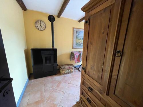 a room with a fireplace and a clock on the wall at IL Casaletto in Subiaco