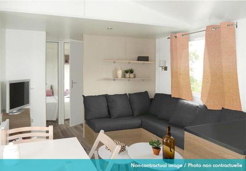 a living room with a couch and a table at Camping Officiel Siblu Domaine de Litteau in Litteau