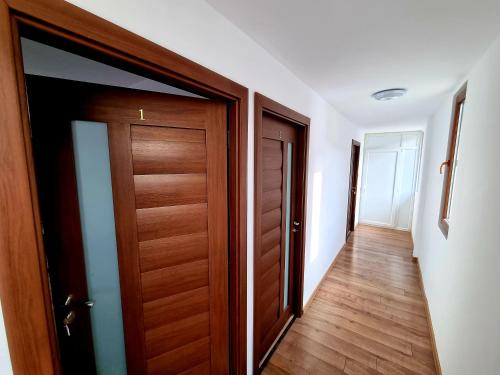 a hallway with two wooden doors in a room at Escape in Dubova