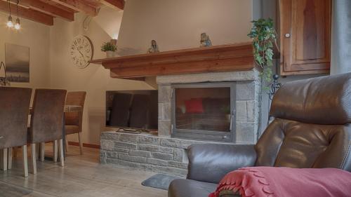 a living room with a fireplace and a television at Saplan Real Estate PORTET in Les