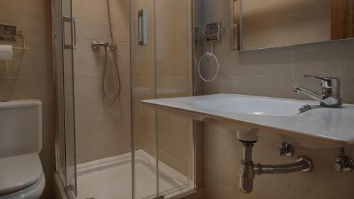 a bathroom with a sink and a shower and a toilet at Saplan Real Estate PORTET in Les