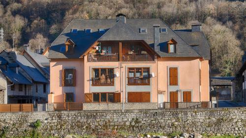 a large house on top of a stone wall at Saplan Real Estate PORTET in Les
