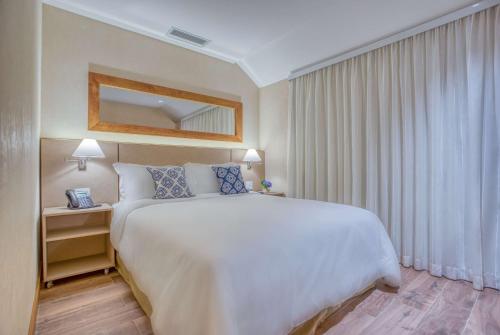 Postel nebo postele na pokoji v ubytování Wyndham Gramado Termas Resort & Spa