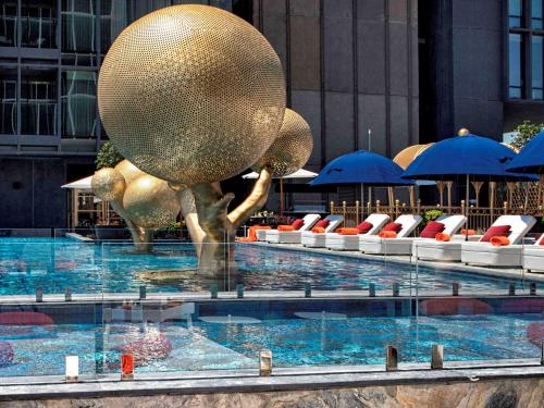 a large elephant swimming in a swimming pool at Fairmont Quasar Istanbul Hotel in Istanbul
