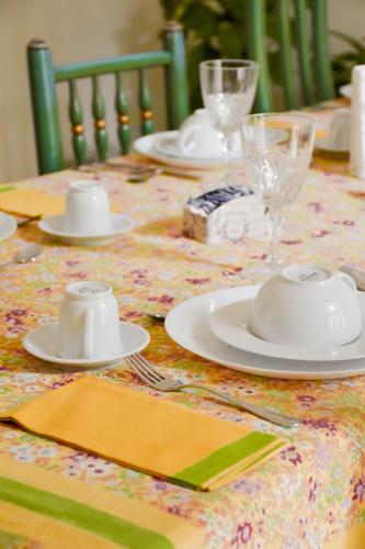 a table with white plates and napkins on a table at Casa Jolanda B&B in Palermo