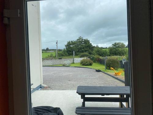a view of a bench from a window at Doughlasha House V93RX64 in Killarney