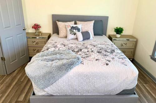 a bedroom with a large bed with two night stands at The Southside Villa- With Private Yard & Free Parking, Minutes From Falls & Casino by Niagara Hospitality in Niagara Falls