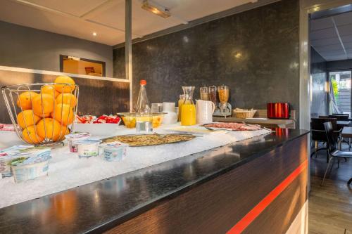 a kitchen with some food on a counter at Comfort Hôtel RUNGIS-ORLY in Rungis