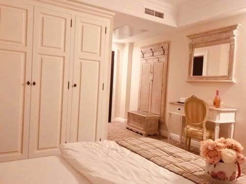 a bedroom with a bed and a desk and a chair at PENSIUNEA DIMITRIOS Relaxare cu jacuzzi pe Valea Cernei in Băile Herculane