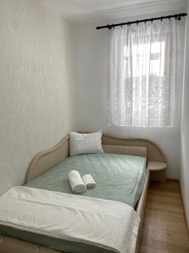 a bedroom with a bed with two white towels on it at Apartment Kirili and Metodi 41-8 in Berkovitsa