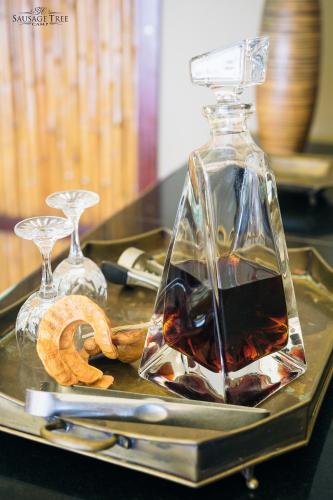 a bottle of wine and some cookies on a tray at Sausage Tree Camp in Jeki