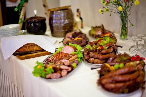 a white table with plates of food on it at Hotel Srebrna Góra in Srebrna Góra