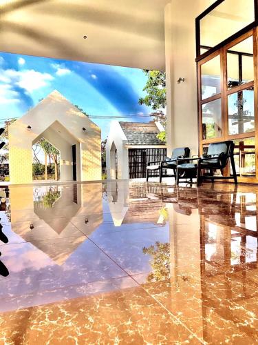 a living room with a reflection of a house at Berghaus101khaoyai in Nakhon Ratchasima