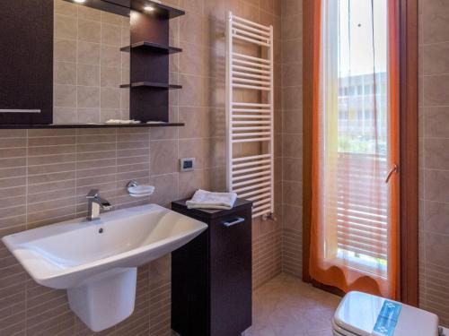 a bathroom with a sink and a toilet at Apartment in Albarella near Sandy Beach in Isola Albarella