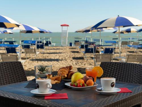 a table with a plate of food on the beach at Apartment in Albarella near Sandy Beach in Isola Albarella