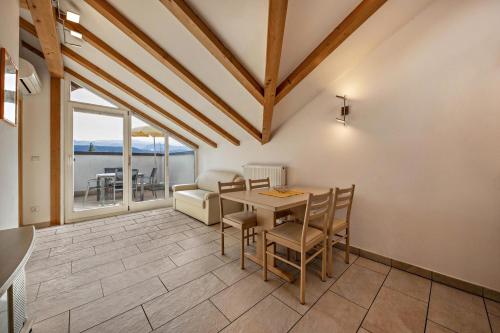a dining room with a table and chairs at Stompferhof Mansarde in Caldaro