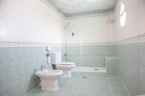 a bathroom with two toilets and a sink at Hotel Blanca Brisa Cabo de Gata in El Cabo de Gata