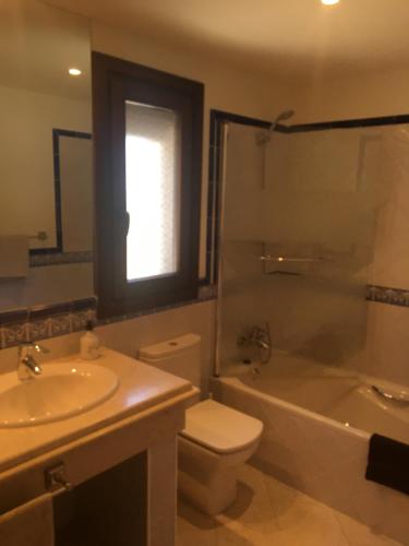 a bathroom with a sink and a toilet and a shower at Casares Village Bed & Breakfast in Casares