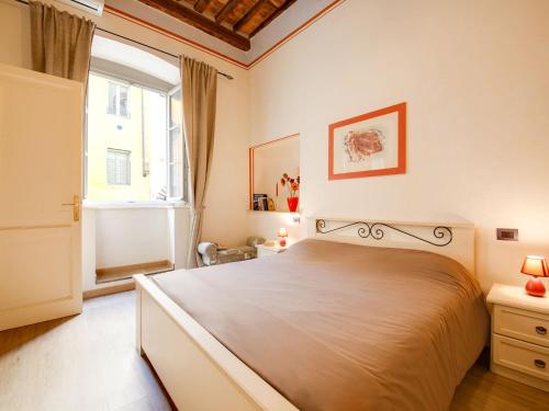a bedroom with a large bed and a window at Mansion in Lucca near Via Fillungo in Lucca