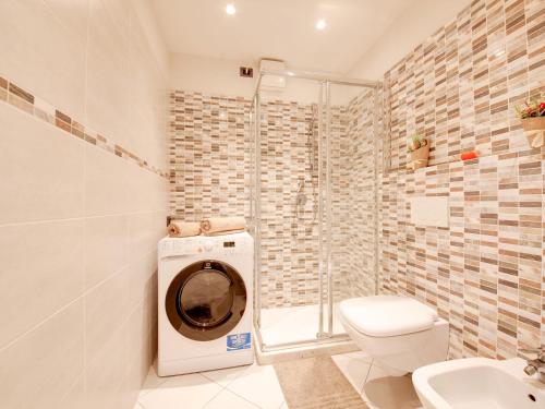 a bathroom with a washing machine and a toilet at Mansion in Lucca near Via Fillungo in Lucca