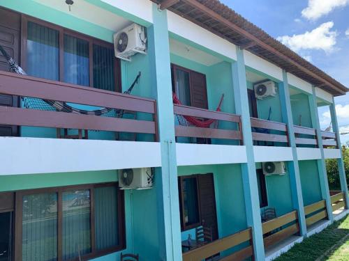 a blue building with hammocks on the balconies at Hotel de Trânsito da PM-PE in Olinda