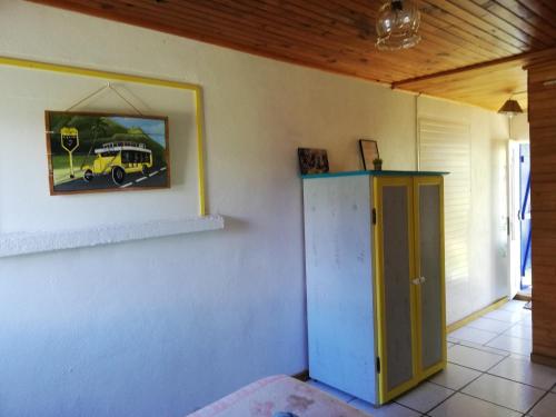 a room with a mirror and a yellow truck on the wall at le p'ti blanc des "o" in Salazie