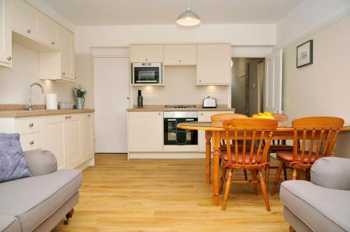 a kitchen and dining room with a table and chairs at Little Lane in Alverstoke