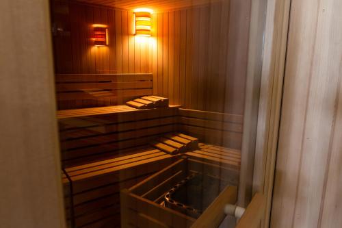 a sauna with wooden benches and lights in it at Hotel & Wellness Stella Delle Langhe in Govone