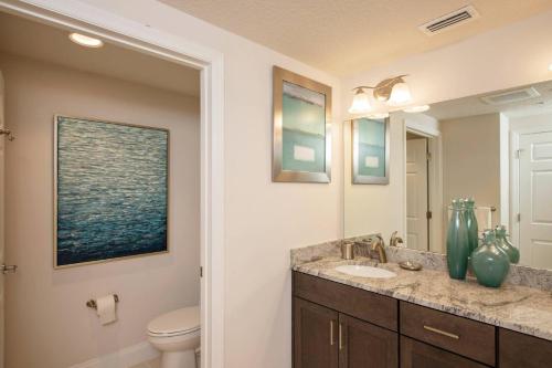 a bathroom with a sink and a toilet at Aruba Condo Unit #1102 in Daytona Beach Shores