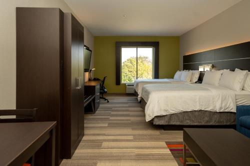 a hotel room with two beds and a window at Holiday Inn Express & Suites Deer Park by IHG in Deer Park