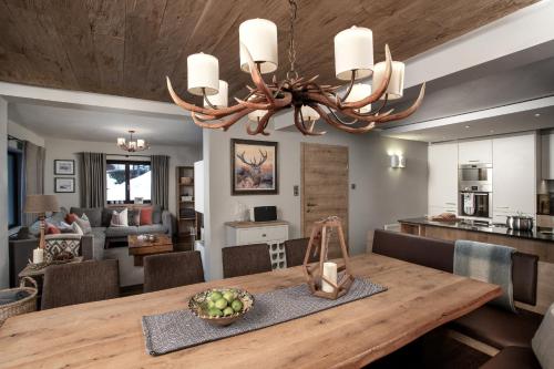 a dining room and living room with a dining table at Chalet Zell by Chalet Alp Lux in Zell am See