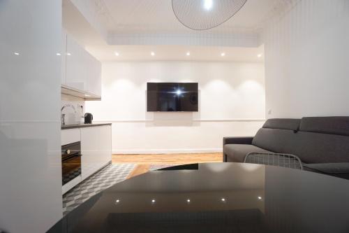 a living room with a couch and a table at Large Flat At 2 Steps From The Eiffel Tower in Paris