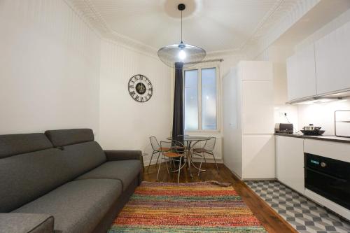 a living room with a couch and a table at Large Flat At 2 Steps From The Eiffel Tower in Paris