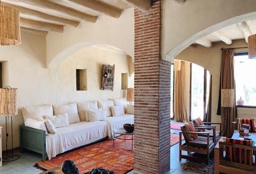 a living room with a white couch in a room at Dar al Hossoun in Taroudant