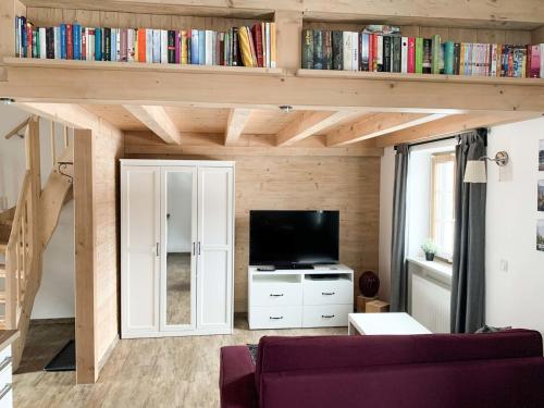 a living room with a couch and a tv at Fewo Aschauer in Schönau am Königssee