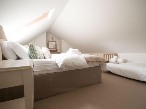 a bedroom with two beds in a attic at No 1 The Hinges in Newquay