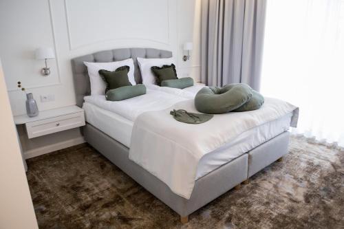 a bedroom with two beds and a large window at Mały Sopot Boutique in Iława