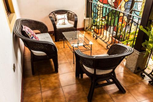 a group of chairs and a table in a room at Hotel T KON T in Antigua Guatemala