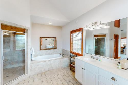 a bathroom with two sinks and a tub and a shower at The Love Boat #15SV-F in Frisco