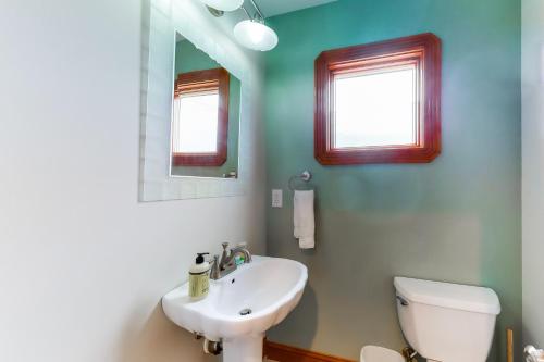 a bathroom with a sink and a toilet and a mirror at The Love Boat #15SV-F in Frisco