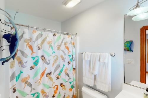 a bathroom with a shower curtain with fish on it at The Love Boat #15SV-F in Frisco