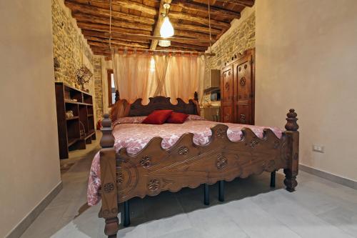 a bedroom with a large wooden bed in a room at Mella Bellagio -La Corte - at the Lake with parking in Bellagio