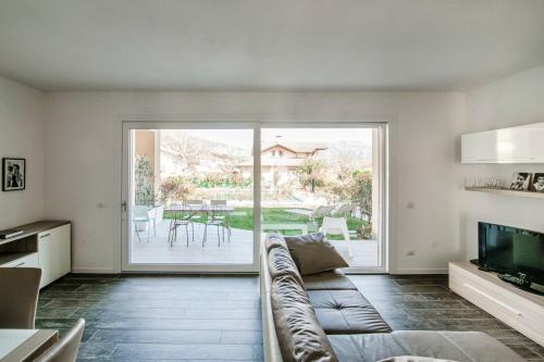 a living room with a couch and a television at Silvia Lenno House - The House Of Travelers in Lenno