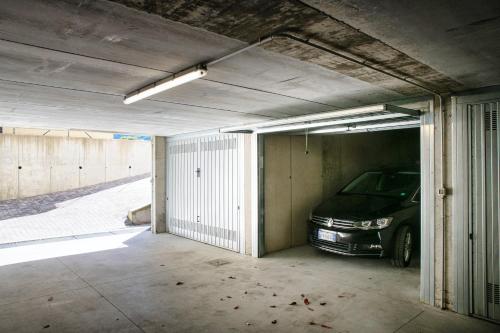 a parking garage with a car parked in it at Silvia Lenno House - The House Of Travelers in Lenno