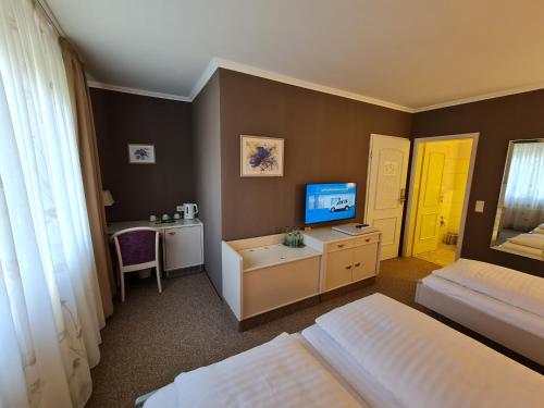 Ένα ή περισσότερα κρεβάτια σε δωμάτιο στο Ambiente Hotel garni