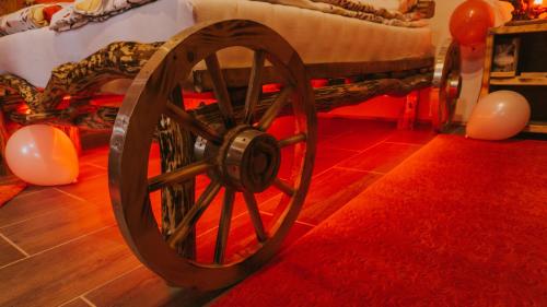 a wooden wagon in a room with balloons at Etno Village Dolina Sreće in Vitez